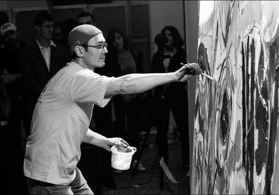 black and white photograph artist painting in studio