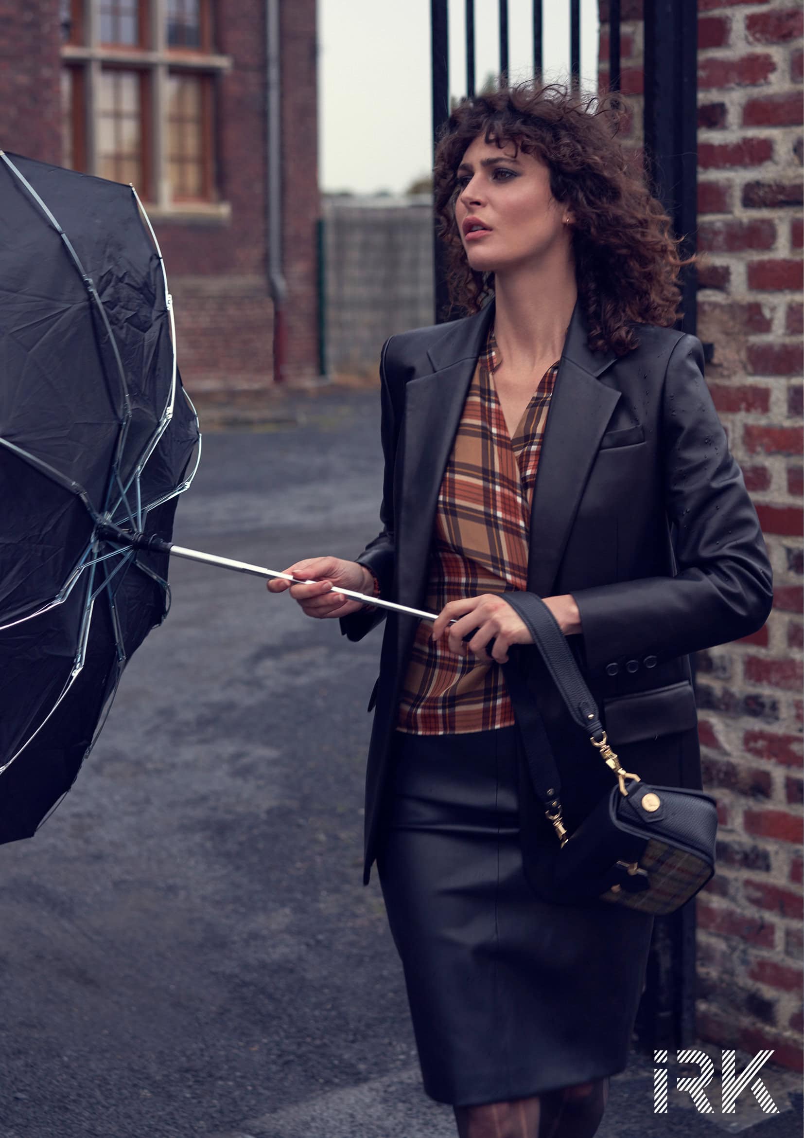 Black leather jacket Barbara Bui, Checkered silk wrap blouse Balenciaga on Yoox.com, leather skirt, Barbara Bui, mini bag in leather and tartan flannel Maison Pourchet, black sheer tights Falke, umbrella Beau Ciel.