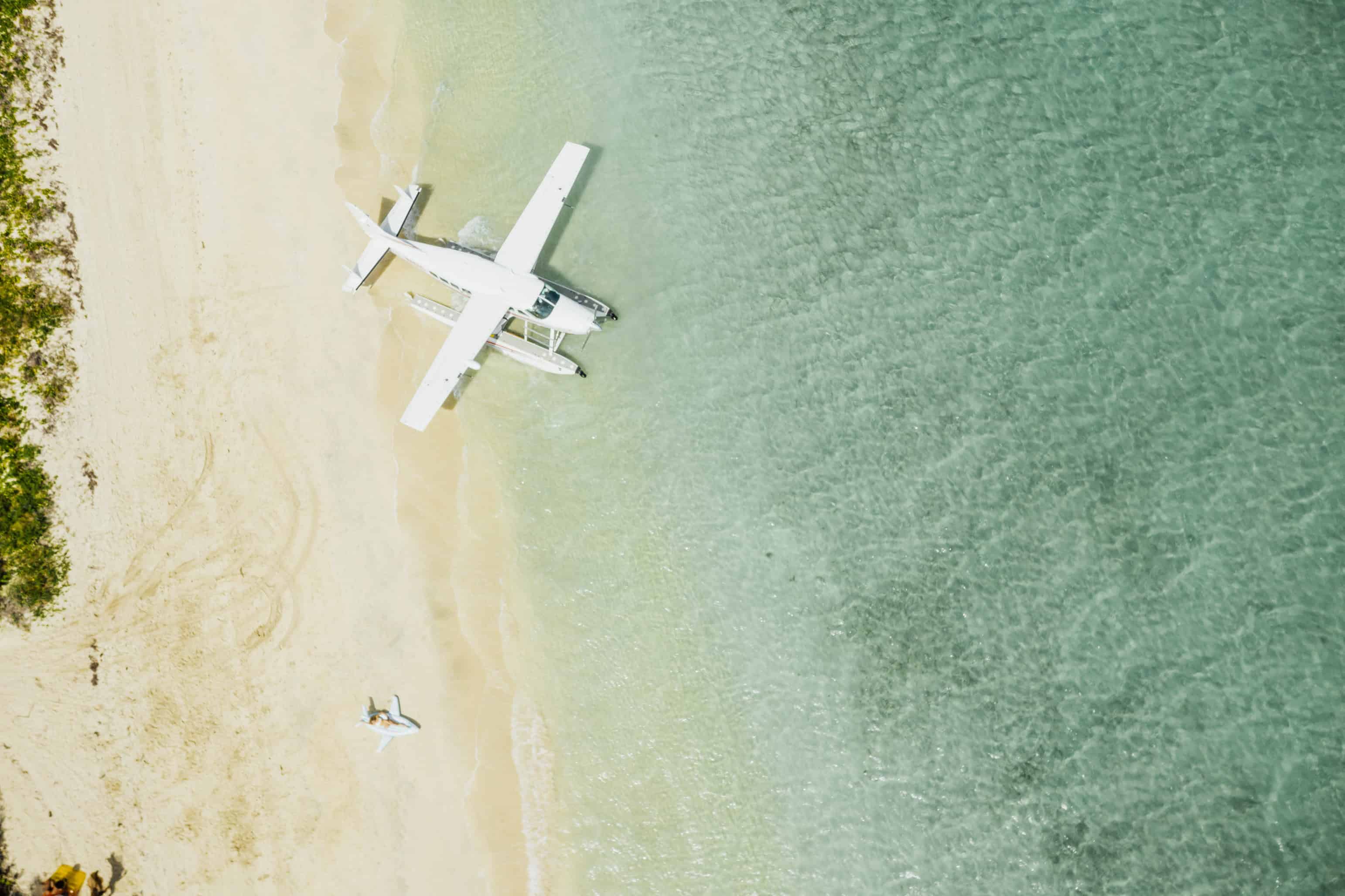 overhead landscape photograph of airplane on Caribbean shoreline in color