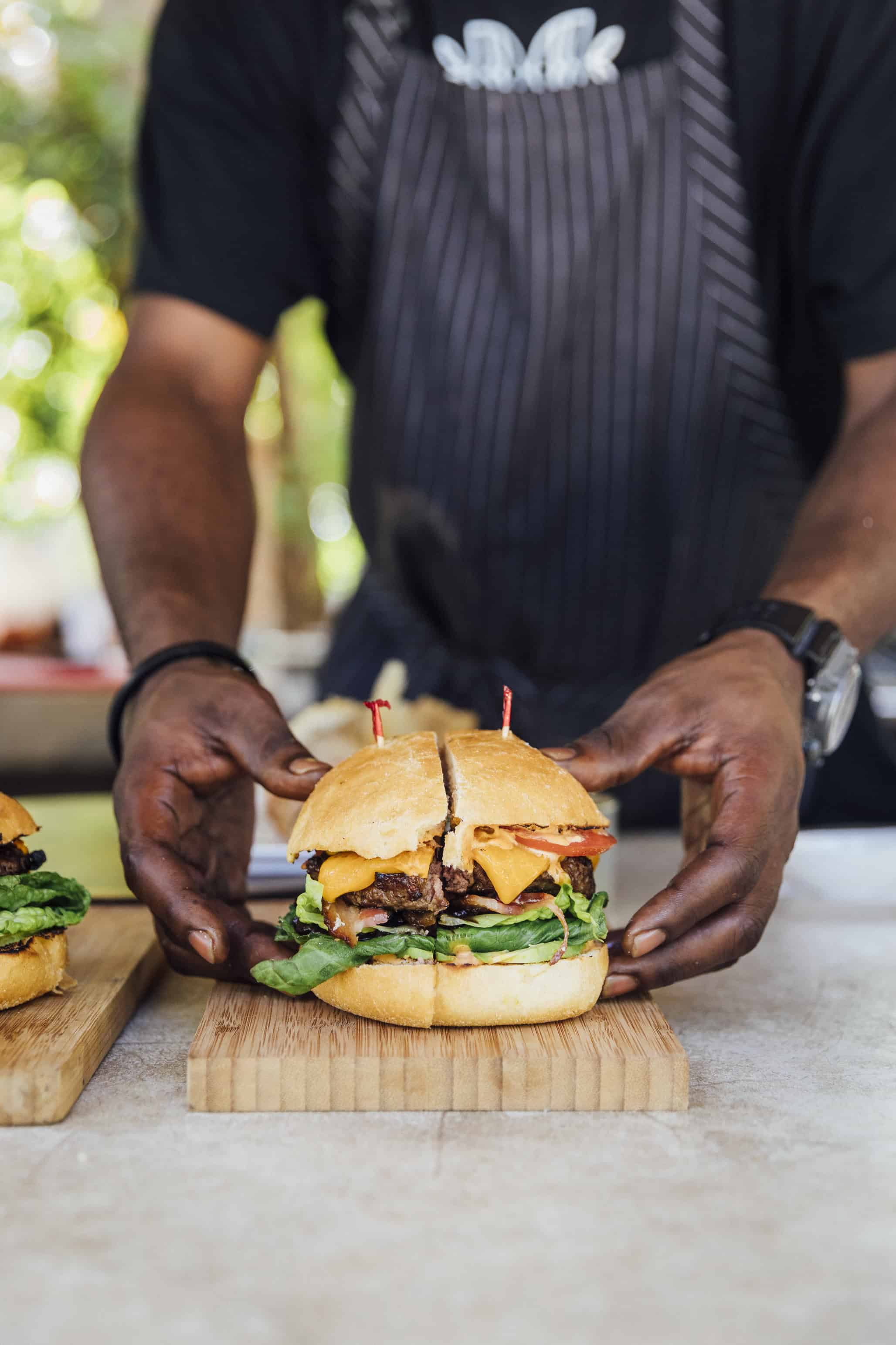 color photograph of man serving burger